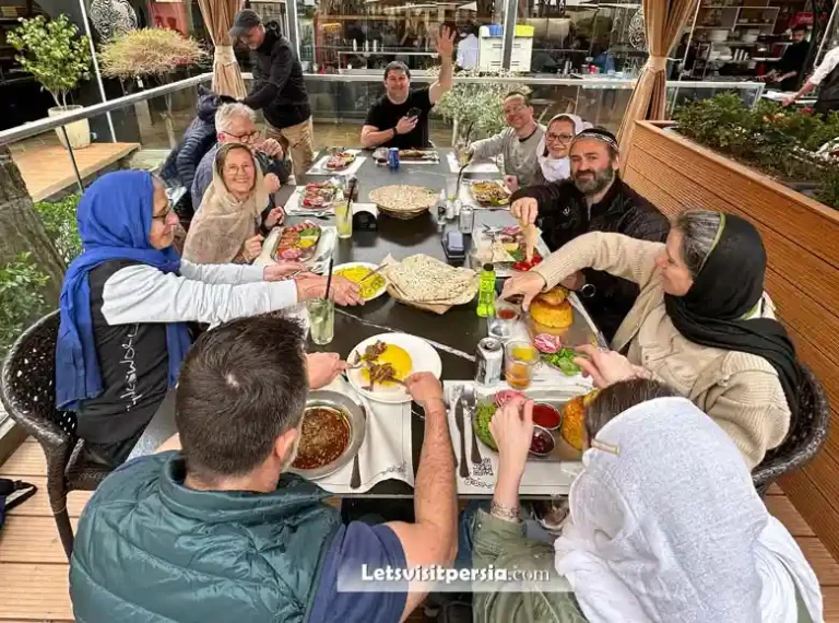 Tourists traveling to Iran with a group enjoying lunch