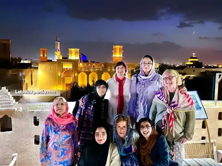 travelers taking a photo with local people in Yazd