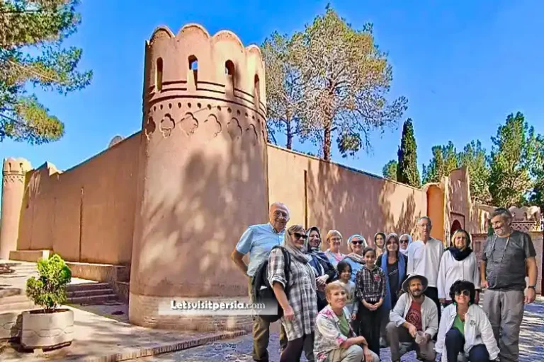 Exterior of Seti Pir Zoroastrian shrine with visitors in Yazd, Iran