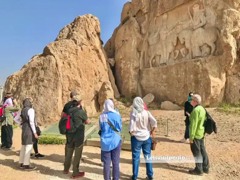 Tourists viewing a Sasanian rock relief at Naqsh-e Rostam near Shiraz